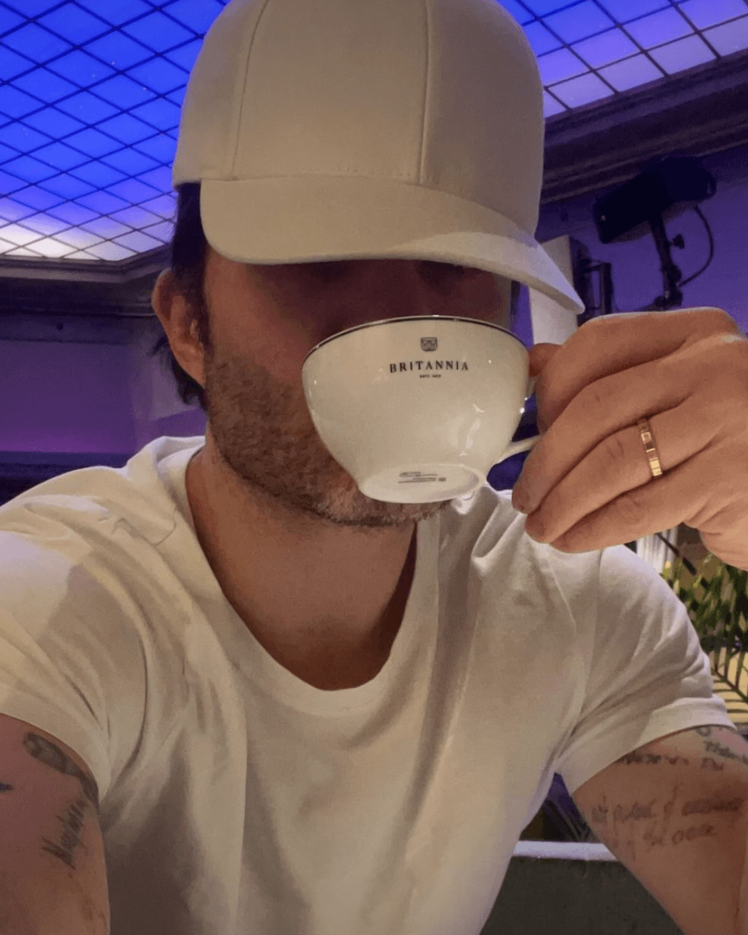Actor Ed Westwick wearing a white alcantara cap from varsity headwear