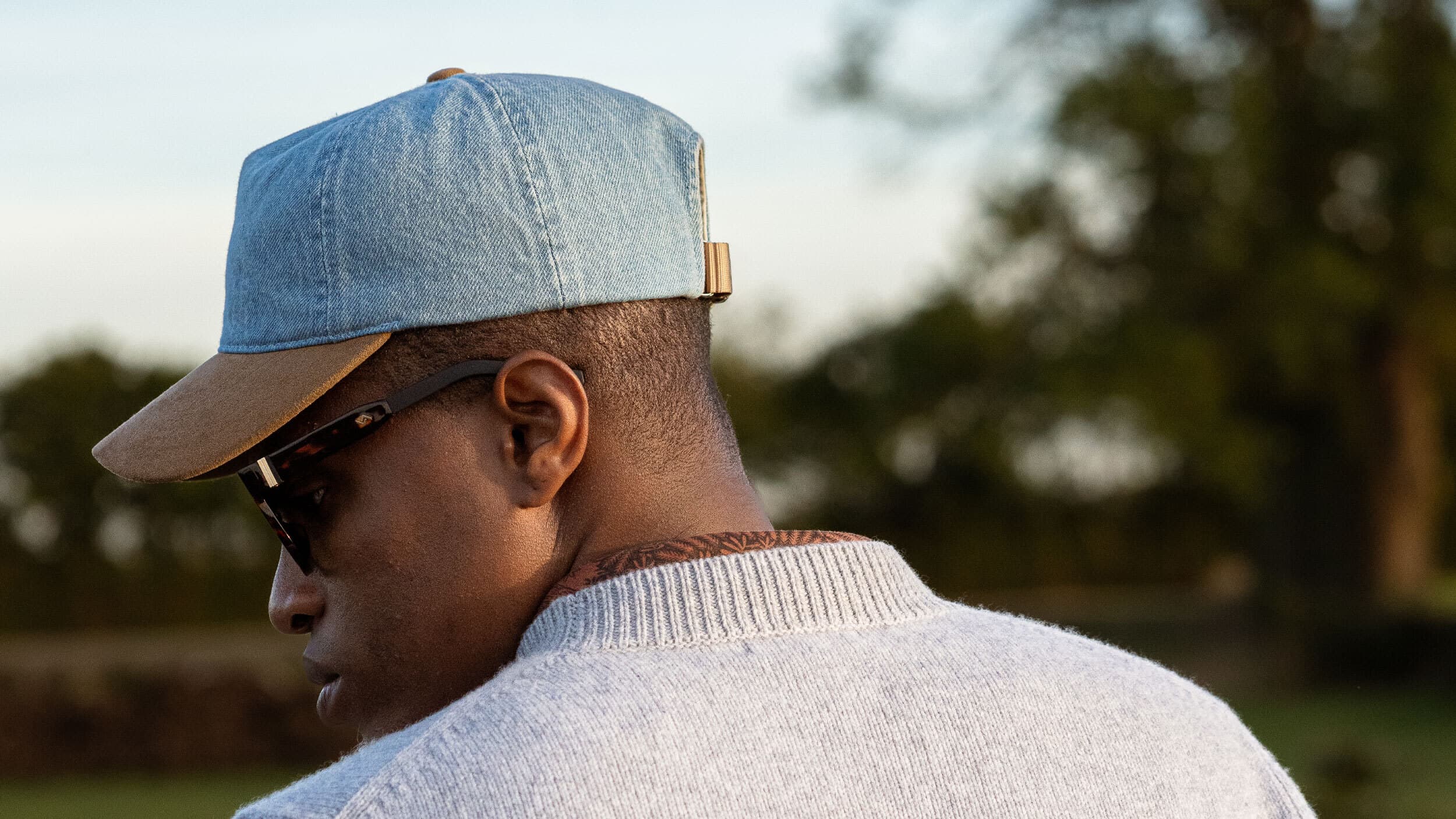Side view of male wearing the Cruz Soft dual denim and alcantara cap