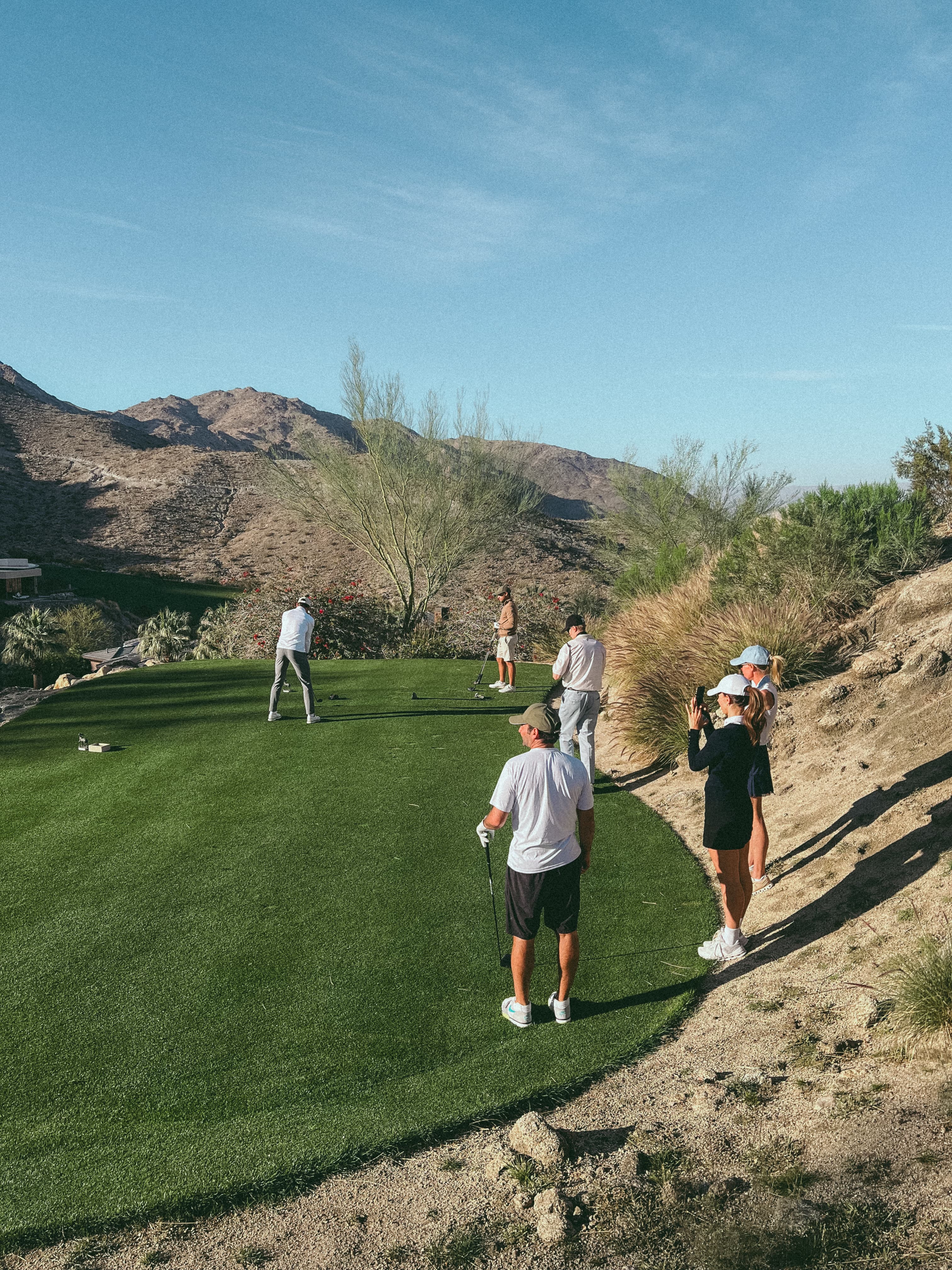Behind the scenes image from the golf course at the campaign shoot with Casper Ruud