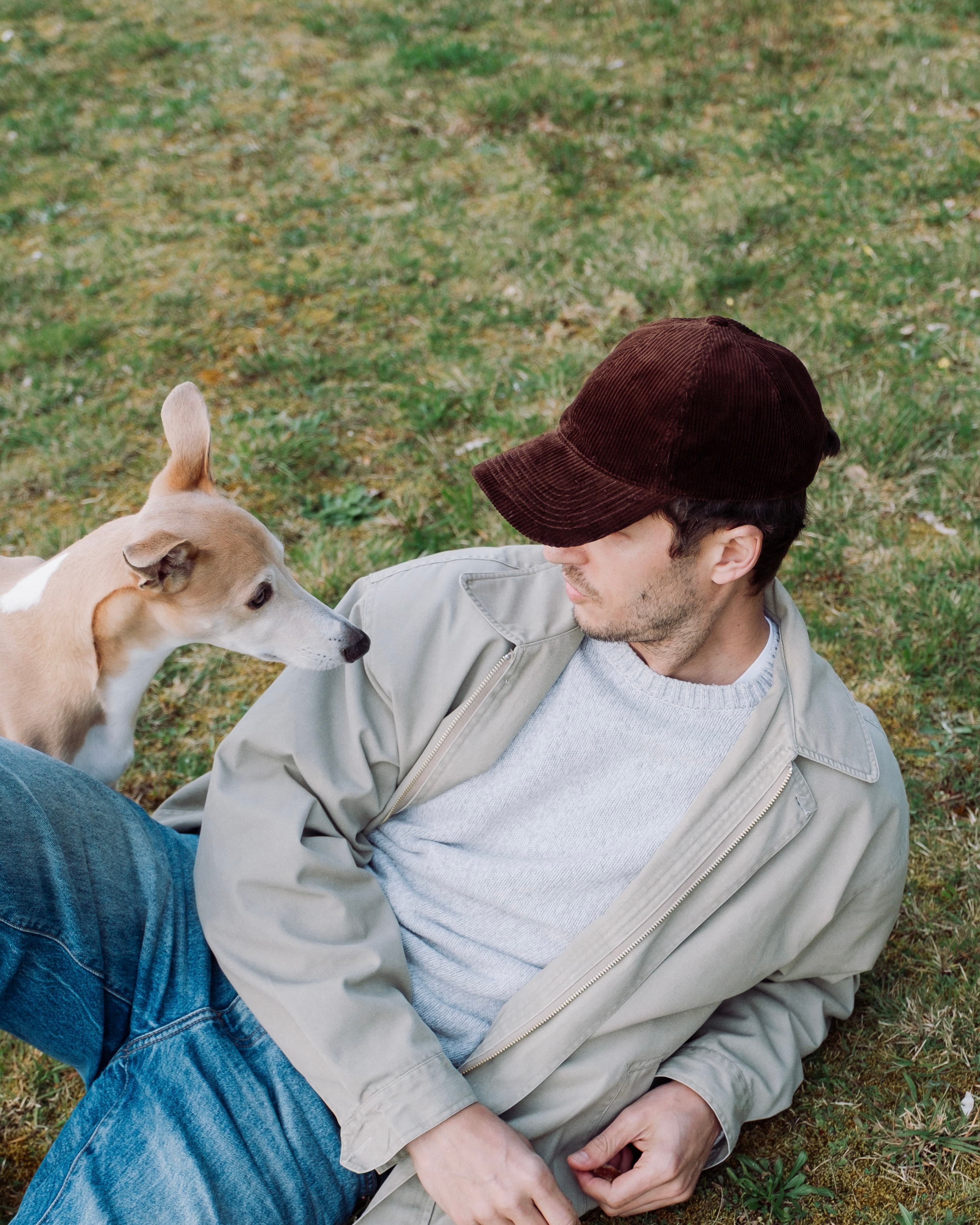 Hedi Sersoub Varsity Headwear ambassador at the country side with his dog and wearing a brown corduroy cap