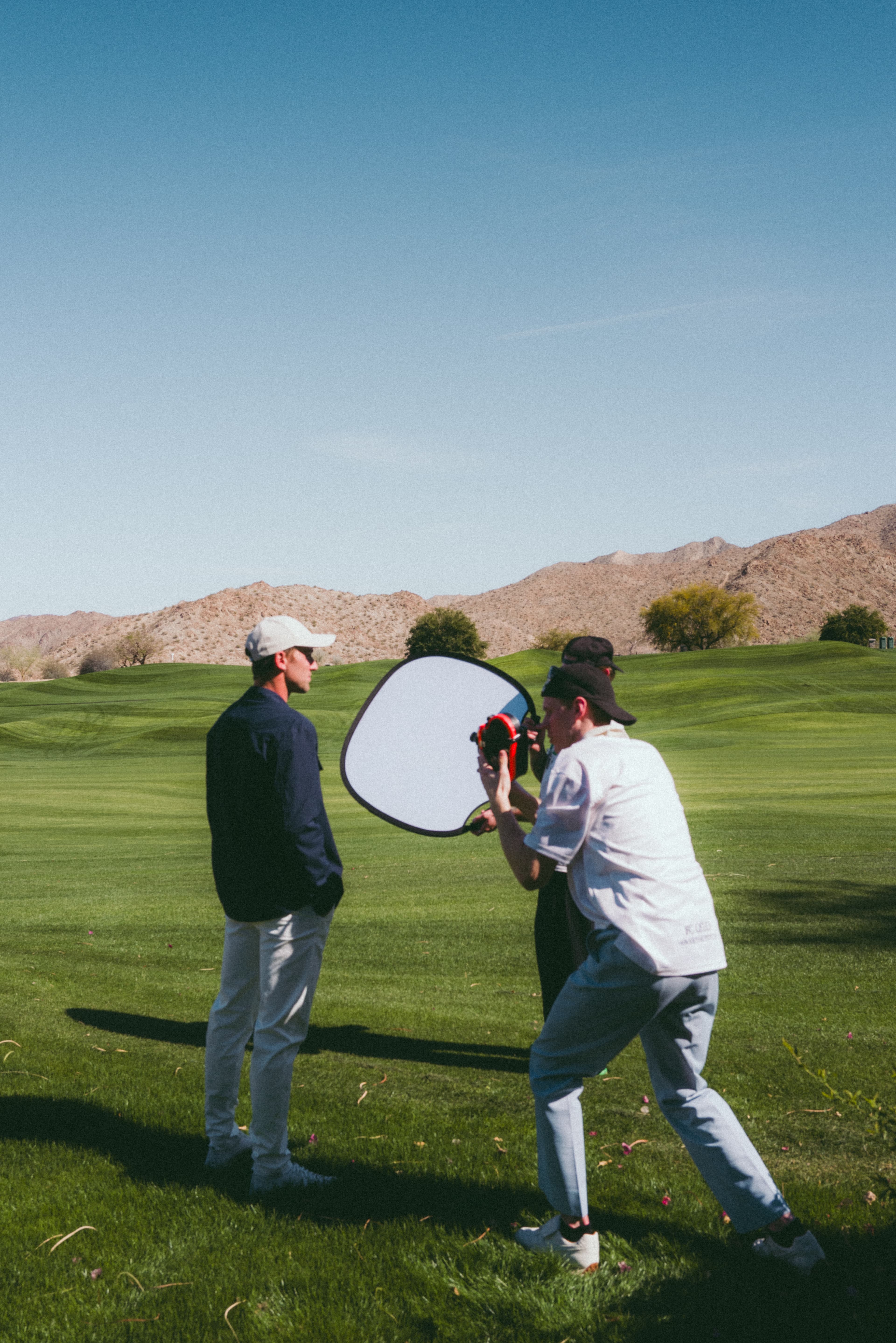 Behind the scenes image of team working at the campaign shoot with Casper Ruud