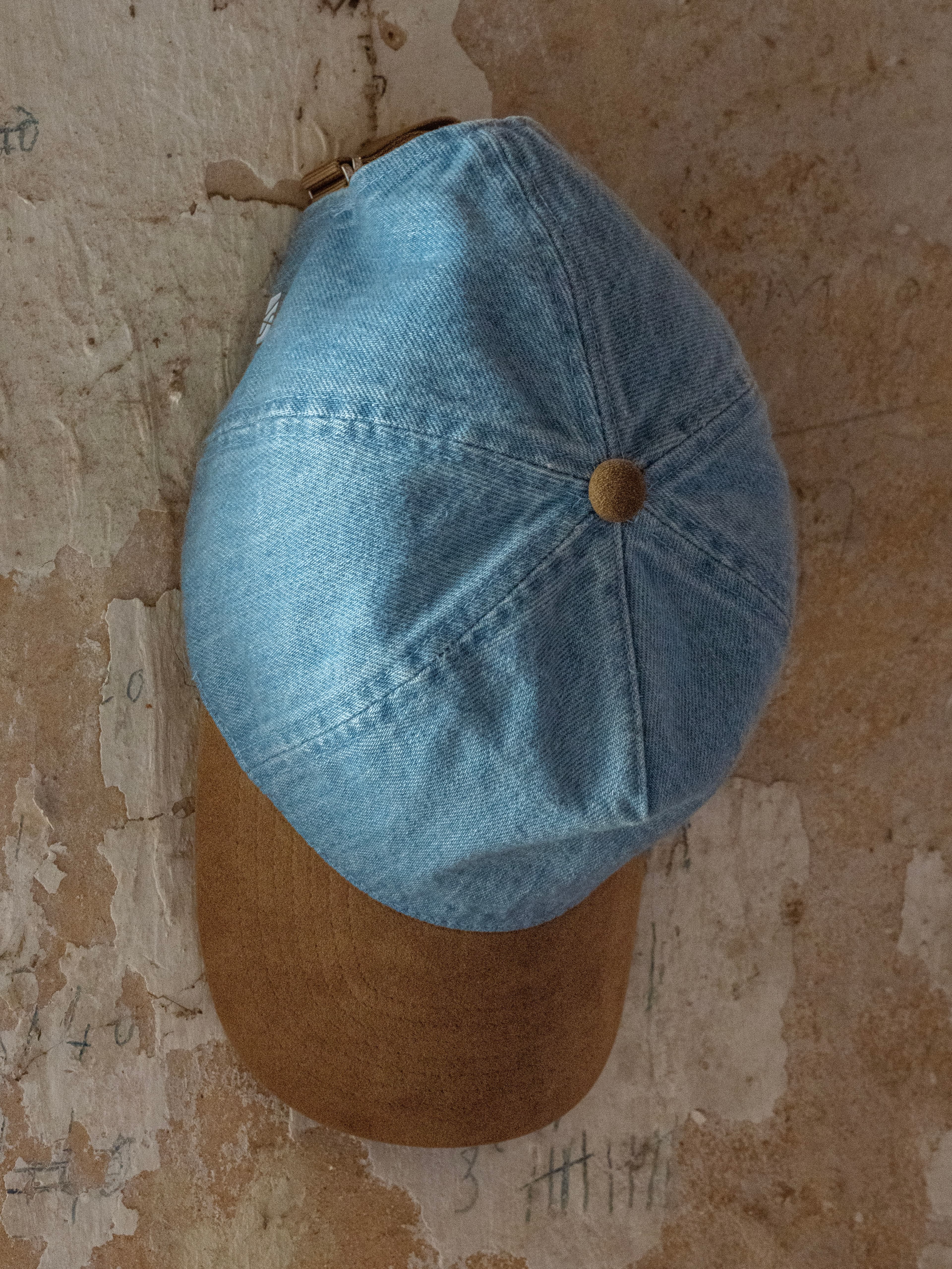 Front view of a blue denim and brown alcantara dual cap in soft cruz