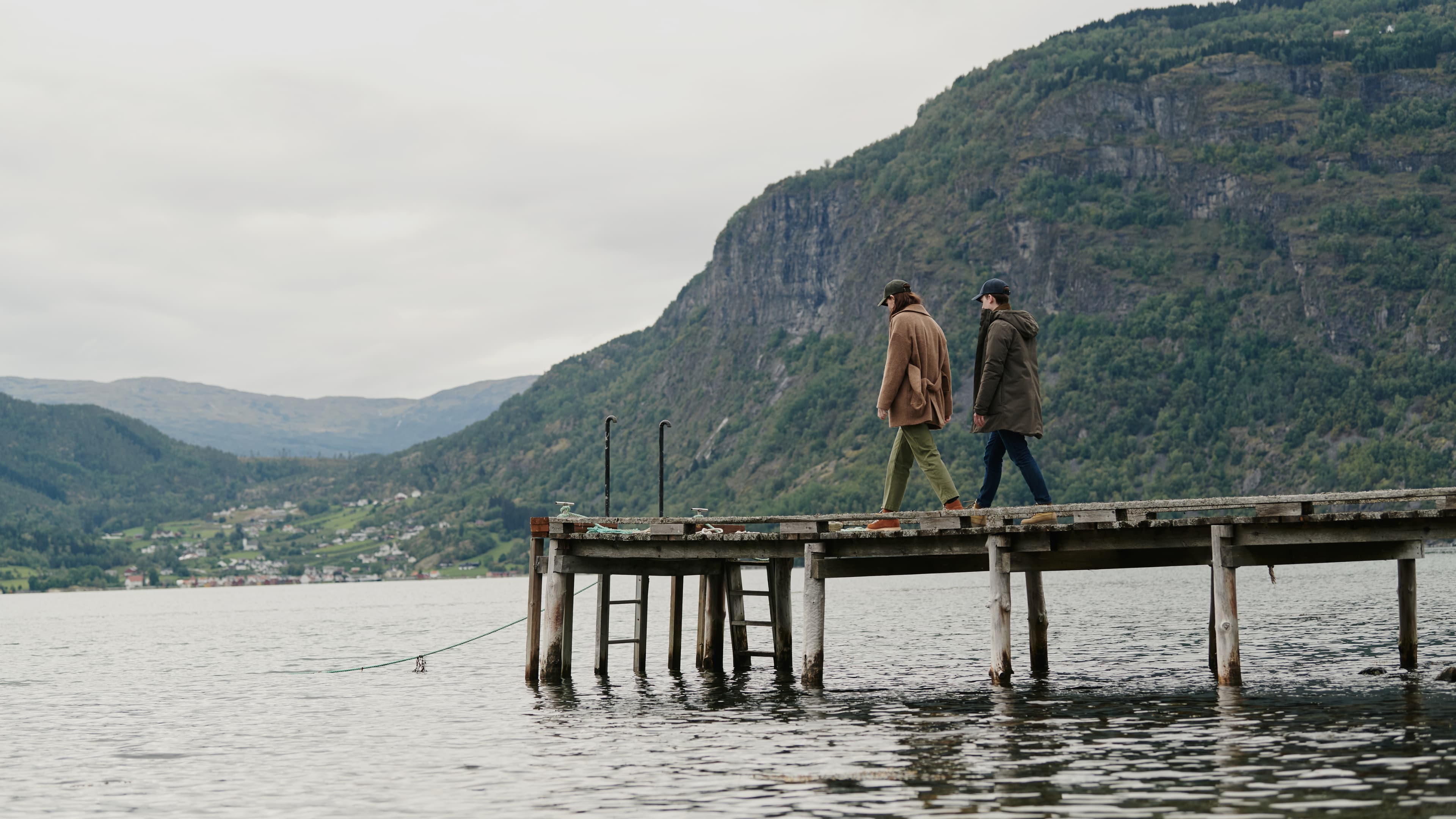 Lifestyle image of female and male model in Norwegian landscape wearing varsity headwear baseball caps