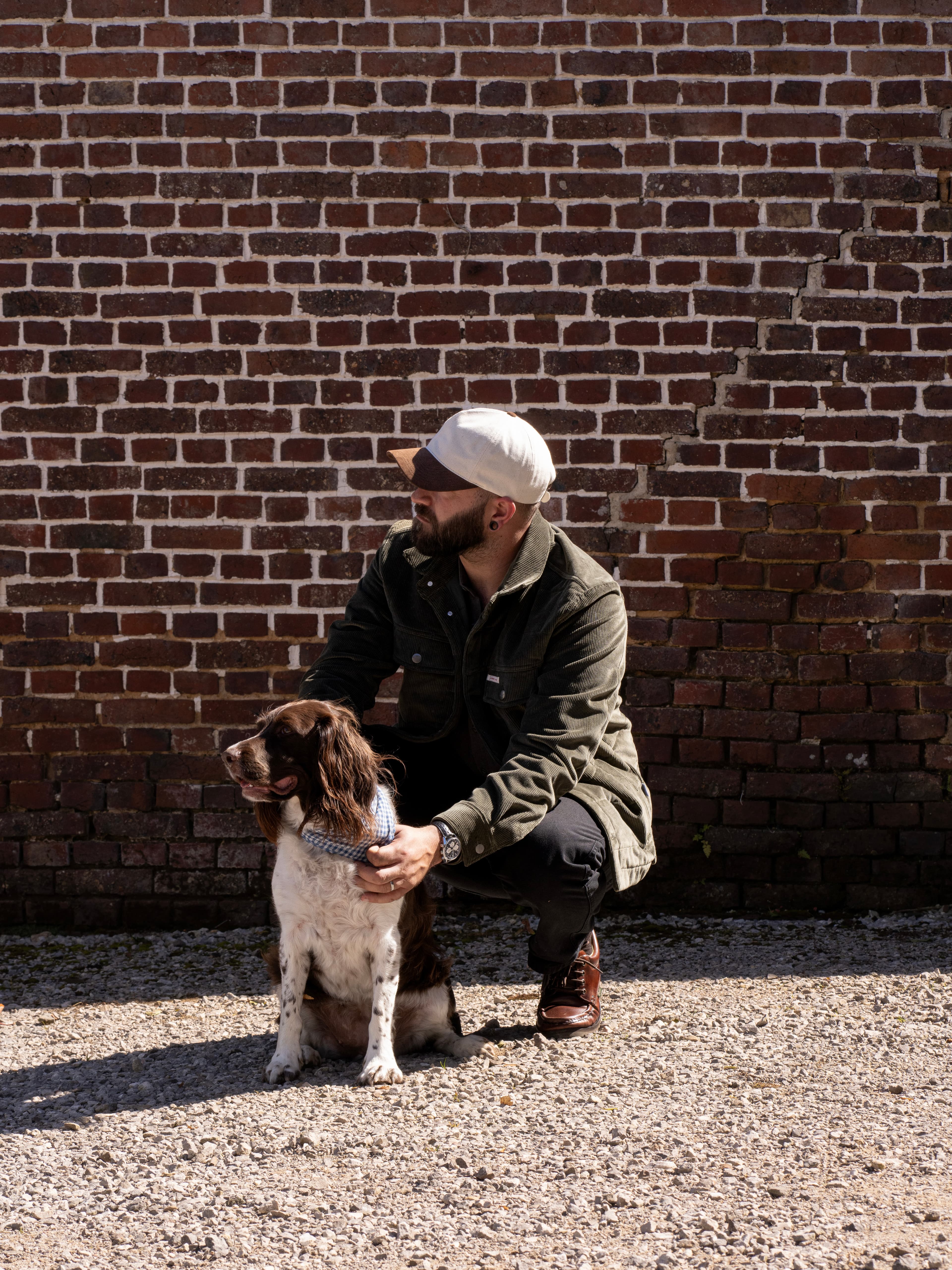 Side view of male wearing the white denim and brown alcantara dual cruz soft cap from varsity Headwear